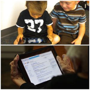 two young boys and an elderly woman using iPads