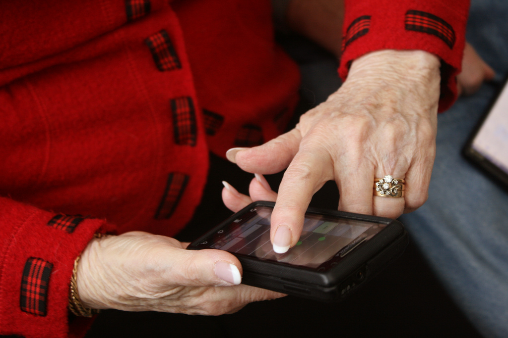 older woman's hands using touchscreen