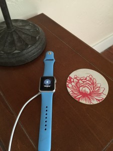 Apple Watch charging on the bedside table.